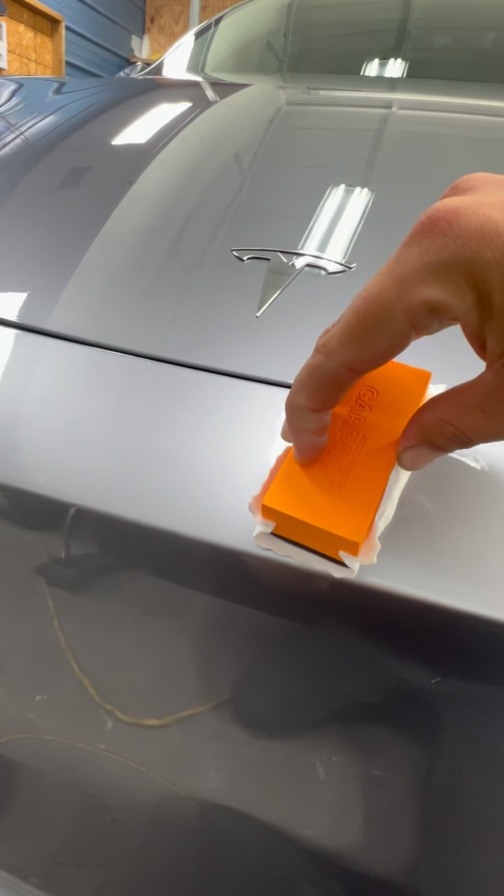 Ceramic coating being applied to Tesla